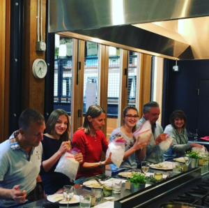 Chef Joe Muscarello preparing a luxury private dining experience with a beautifully plated gourmet meal in a client's home kitchen.